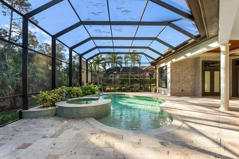 Swimming pool with caged jacuzzi