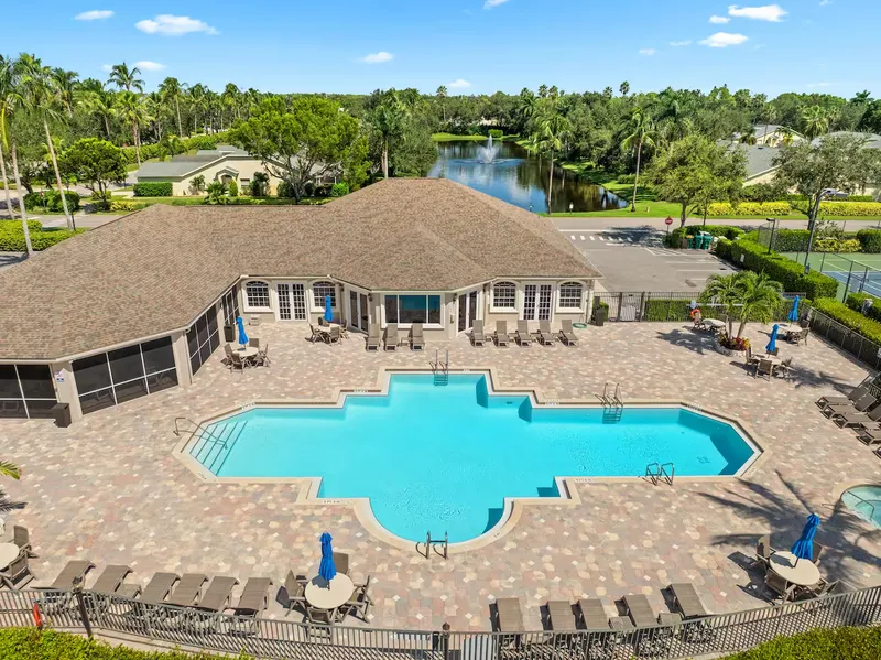 A recreational patio with a large outdoor pool